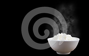 Isolated of Hot Steamed Rice in a White Bowl with White Vapor on dark background