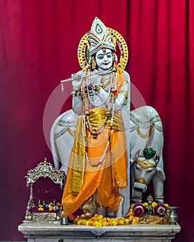 Isolated idol of Hindu God Krisna with flute in a temple at Somnath. photo