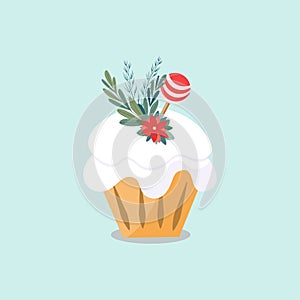 Isolated image of a Christmas muffin. The pastry is decorated with white frosting, candy, red flower and small Christmas tree bran