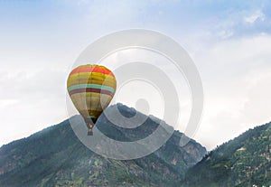 Isolated image of hot air balloon high in the air  in Manali, Himachal Pradesh, India. photo