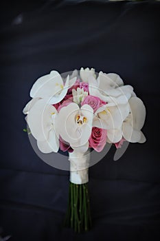 Isolated large orchids and cyclamen roses bridal bouquet