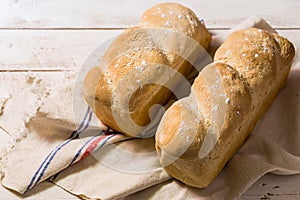 Isolated loaf of bread on a wooden board