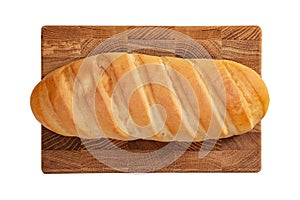 Isolated loaf of bread on wooden rectangular cutting board on white background.