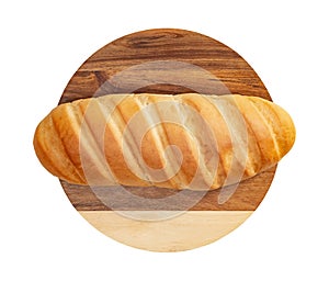 Isolated loaf of bread on wooden round cutting board on white background.