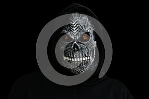 Isolated man dressed in death carnival costume on black background with fire on eyes. Halloween holiday concept. Scary