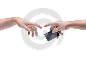 Two male hands passing one another a black plastic discount or credit card on white background photo