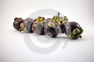 Isolated mangosteens. Plenty fruits isolated on white background