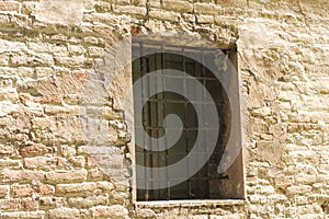 Isolated medieval window with iron gratings