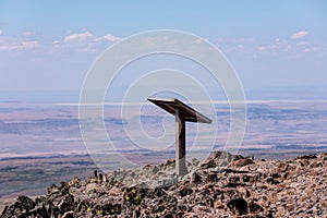 Isolated metal information stand on a top of a mountain