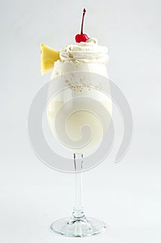 Isolated milkshake with pineapple and cherry