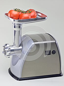 Isolated mincer with tomatoes