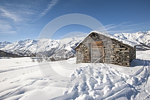 Isolated mountain hut in the snow