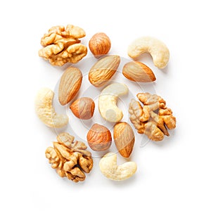 Isolated nuts pattern background. Walnut, cashew, almond and hazelnut on white background. View from above