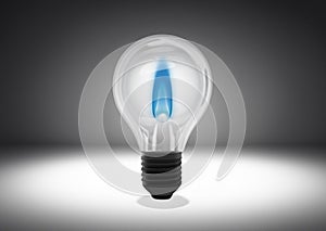 Isolated object shot of a light bulb with a blue flame inside on a dark background