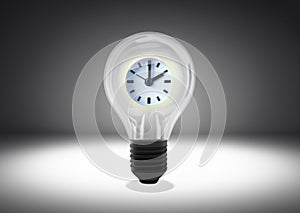 Isolated object shot of a light bulb with a clock inside on a dark background