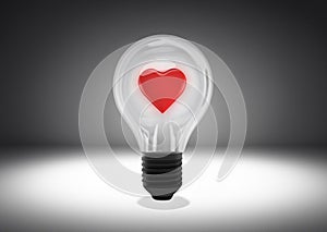 Isolated object shot of a light bulb with a heart inside on a dark background