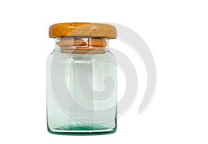 Isolated old glass jar with wooden lid. Vintage glass jar on white background, front view, empty space in the jar