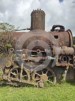 Isolated old rusty machinery wheel in Martinique island. French West Indies