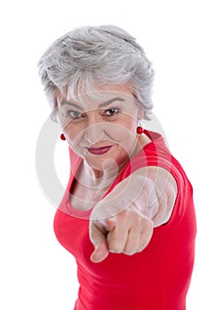 Isolated older woman is pointing with her finger.