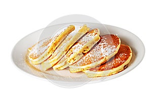 Isolated pancakes with icing sugar on white