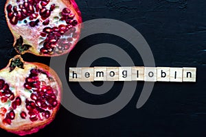 Isolated photo focused on Hb Hemoglobin and iron pills for increasing Hb in blood and garnet or pomegranate