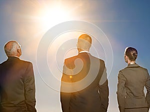 Isolated photo of Rear view of three business people looking at sun