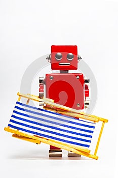 Isolated photo of red toy robot holding deckchair