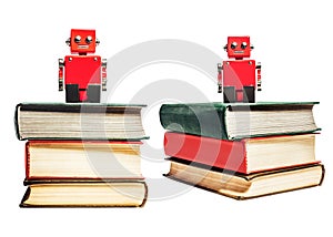 Isolated photo of red toy robot sitting on books