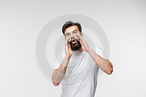 Isolated on pink young casual man shouting at studio