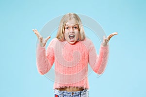 Isolated on pink young casual teen girl shouting at studio