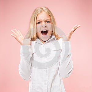 Isolated on pink young casual teen girl shouting at studio