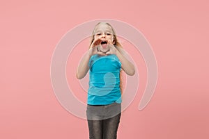 Isolated on pink young casual teen girl shouting at studio