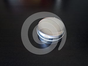 Isolated Plain round tin cannister on a dark background holding unknown contents version 2