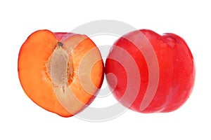 Isolated plums. One and a half of red plum fruit with leaves isolated on white background.