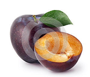 Isolated plums. Whole and a half of blue plum fruit with leaves isolated on white background, with clipping path