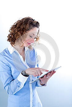 Isolated portrait of a beautiful young woman working with tablet computer