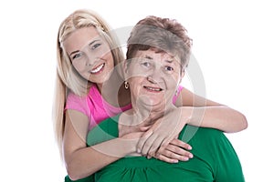 Isolated portrait of blond granddaughter hugging her grandmother
