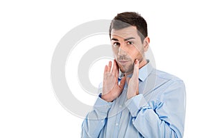 Isolated portrait of a business man wearing blue shirt with surprised and shocked expression.