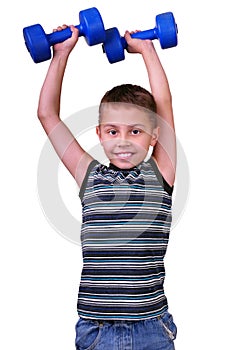 Isolated portrait of elementary age boy with dumbbells exercising