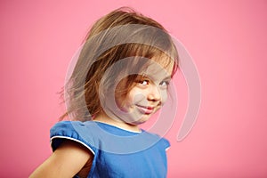 Isolated portrait of little girl with a cunning look.