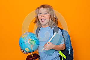 Isolated portrait of school child. School pupil with world globe and book. Little student learning, study geography or