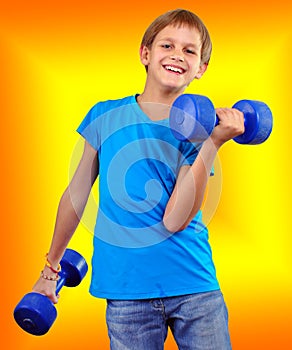 Isolated portrait of smiling kid exercising with dumbbells