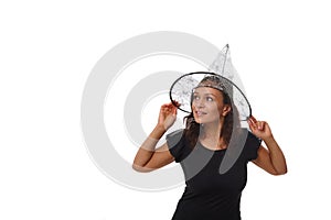 Isolated portrait on white background of an attractive young woman smiling with beautiful toothy smile, wearing a witch wizard hat