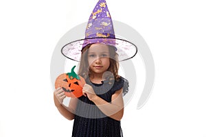 Isolated portrait on white background with copy space of beautiful baby little girl, 4 years old pretty kid wearing a wizard hat,