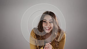 Isolated portrait of a woman who is listening to exciting story and encouraging somebody in slowmo