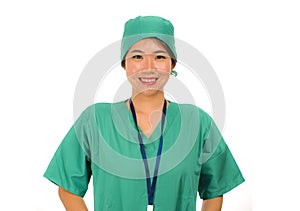 Isolated portrait of young beautiful and happy Asian Korean medicine doctor woman or hospital nurse in medical hat and scrub