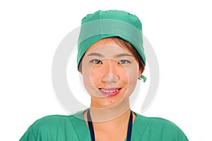 Isolated portrait of young beautiful and happy Asian Korean medicine doctor woman or hospital nurse in medical hat and scrub