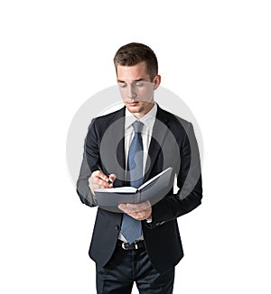 Young businessman writing in notebook, isolated