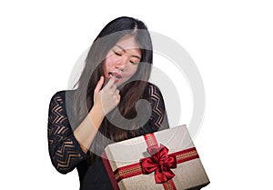 Isolated portrait of young happy and excited beautiful Asian Japanese woman receiving a romantic anniversary gift box holding the