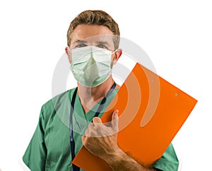 Isolated portrait of young medicine doctor or nurse man in face mask holding clipboard medical paperwork on white background in